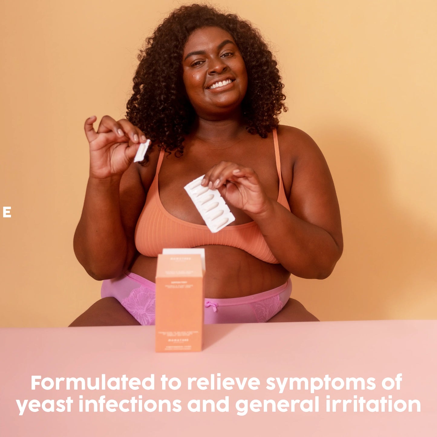 Formulated to relieve symptoms, Black girl holding a suppository pack in hand.